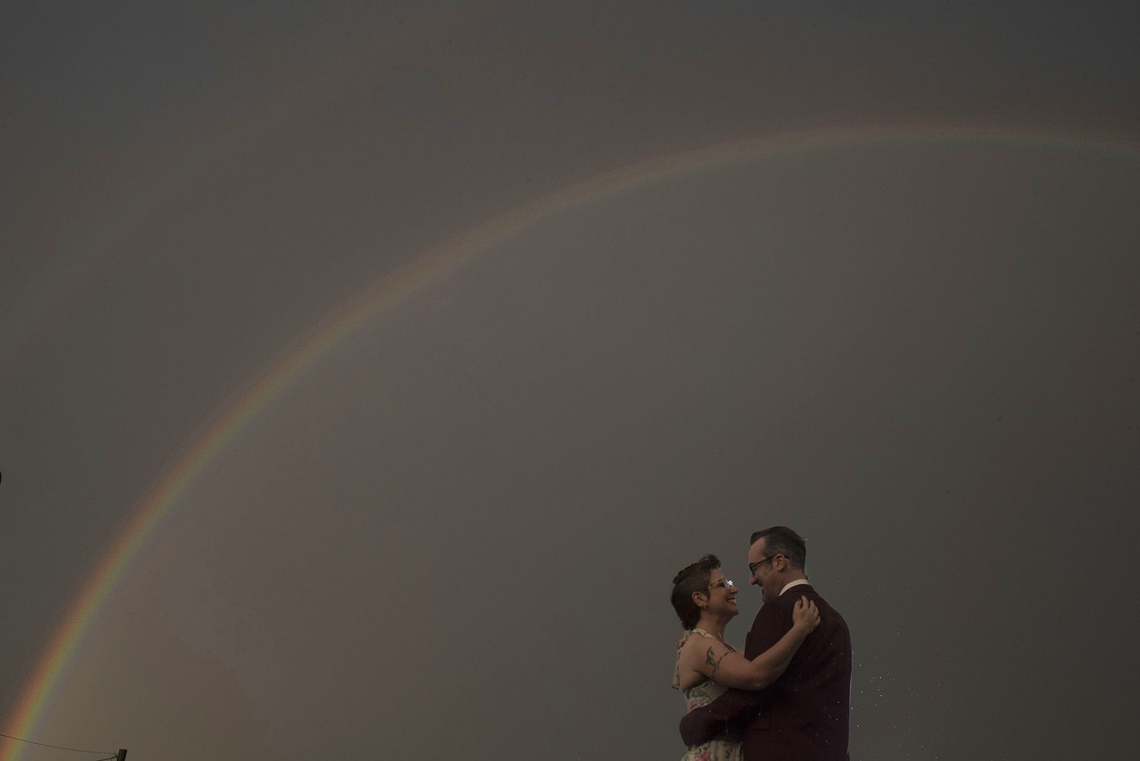 Bride and groom double rainbow